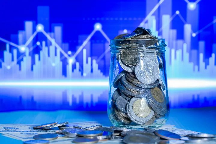 Jar of coins against a market graph
